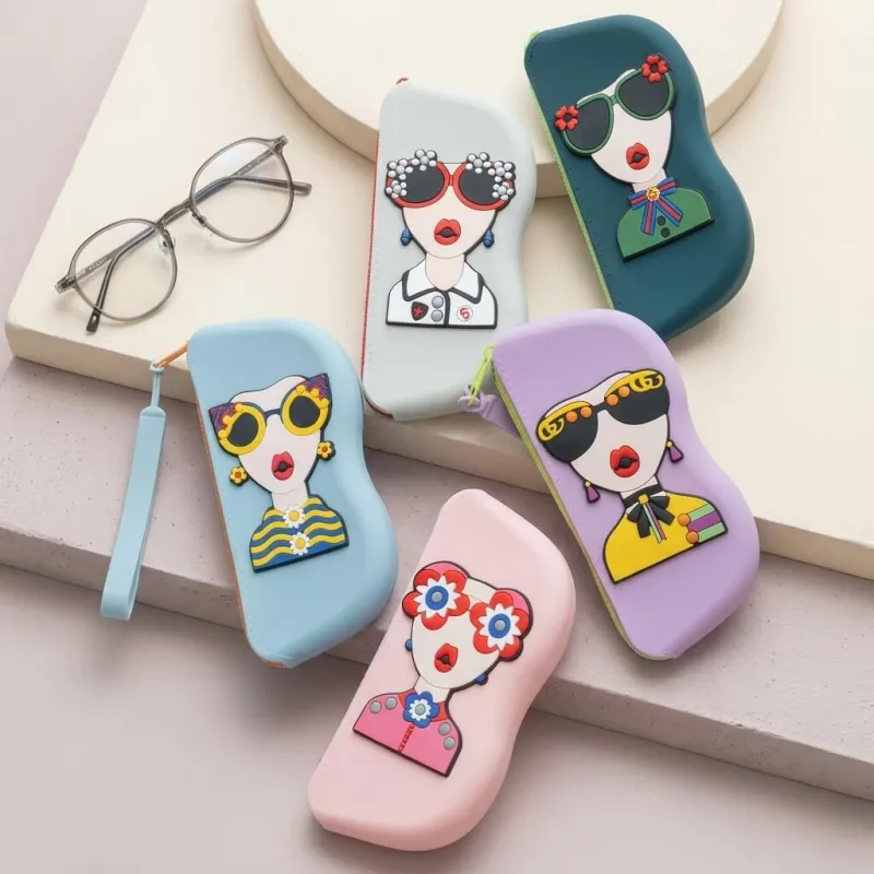Five Cartoon Sunglasses Case pouches in various pastel colors displayed with a pair of eyeglasses on a table.