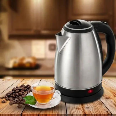 Panasonic 2L Stainless Steel Electric Kettle - Fast Boiling placed on wooden surface next to coffee beans and tea cup