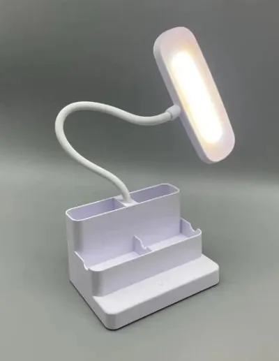 White LED study lamp with pen holder illuminated with warm light, displaying its flexible neck and organizer base.