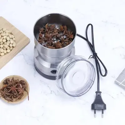 Top-down view of Nima Electric Grinder with lid open and star anise inside the stainless steel bowl.