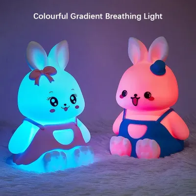 Silicone Bunny Night Light figures glowing with cyan and pink colourful RGB gradient lights in the dark.